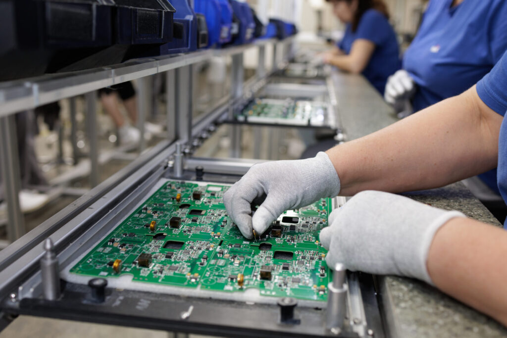 Gloved technician assembling PCB on modern SMT production line 6 Insights 1024x683